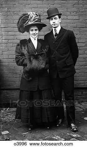 1800S 1890S Turn Of The 20Th Century Couple Stylish Fashionable Clothes Man Bowler Hat Woman Plumed Hat Looking At Camera View Large Photo Image Stock Photograph - 1800S 1890S Turn Of The 20Th Century Couple Stylish Fashionable Clothes Man Bowler Hat Woman Plumed Hat Looking At Camera. Fotosearch