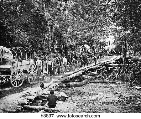 1860s 1864 SHERMANS MARCH UNION TROOPS BUILDING A CORDUROY ROAD THROUGH SOUTHERN SWAMP DURING AMERICAN CIVIL WAR View Large Photo Image Stock Photo - 1860s 1864 SHERMANS MARCH UNION TROOPS BUILDING A CORDUROY ROAD THROUGH SOUTHERN SWAMP DURING AMERICAN CIVIL WAR. Fotosearch