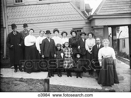 1890 1890S Turn Of 20Th Century Group Portrait Family Three Generations Standing Posing By Side Of House Looking At Camera View Large Photo Image Picture - 1890 1890S Turn Of 20Th Century Group Portrait Family Three Generations Standing Posing By Side Of House Looking At Camera. Fotosearch