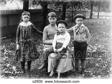 1890S 1900S Family Group Portrait Siblings Girl Sister Two Boys Brothers Outside In Backyard With Mother Looking At Camera View Large Photo Image Stock Photography - 1890S 1900S Family Group Portrait Siblings Girl Sister Two Boys Brothers Outside In Backyard With Mother Looking At Camera. Fotosearch