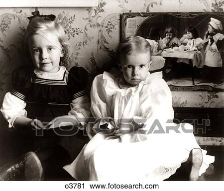 1890s 1900s TURN OF THE 20TH CENTURY PORTRAIT TWO ANONYMOUS YOUNG GIRLS SISTERS TODDLERS SITTING TOGETHER LOOKING AT CAMERA View Large Photo Image Stock Image - 1890s 1900s TURN OF THE 20TH CENTURY PORTRAIT TWO ANONYMOUS YOUNG GIRLS SISTERS TODDLERS SITTING TOGETHER LOOKING AT CAMERA. Fotosearch