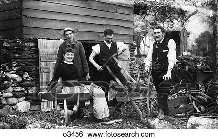 1890S Three Men One Woman By House Shed Looking At Camera One Man Cutting Firewood Logs With Frame Saw View Large Photo Image Stock Photograph - 1890S Three Men One Woman By House Shed Looking At Camera One Man Cutting Firewood Logs With Frame Saw . Fotosearch
