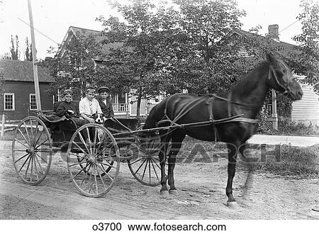 Stock Image - 1890S Turn Of The 20Th Century Three Boys Looking At Camera Sitting Riding In Horse Drawn Carriage With Dog . Fotosearch