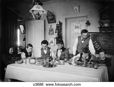 1900S 1901 Turn Of 20 Century Family Three Generations At Kitchen Table New Years Celebration View Large Photo Image Stock Photograph - 1900S 1901 Turn Of 20 Century Family Three Generations At Kitchen Table New Years Celebration. Fotosearch