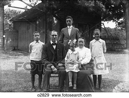 1900S 1918 Family Portrait Mother Father Children Two Sons Two Daughters Posing Outside In Backyard Looking At Camera View Large Photo Image Stock Photo - 1900S 1918 Family Portrait Mother Father Children Two Sons Two Daughters Posing Outside In Backyard Looking At Camera. Fotosearch