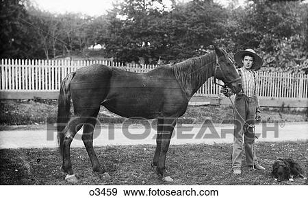 1900S Boy Farmer Wearing Overalls Straw Hat Standing Next To Horse With Dog View Large Photo Image Stock Photo - 1900S Boy Farmer Wearing Overalls Straw Hat Standing Next To Horse With Dog. Fotosearch
