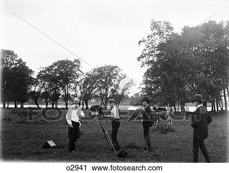 1900S Man Photographer Using Large Format Camera Photographing Cows In Field With Three Teenaged Boys Assistants View Large Photo Image Stock Image - 1900S Man Photographer Using Large Format Camera Photographing Cows In Field With Three Teenaged Boys Assistants. Fotosearch