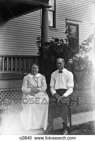 1900S Portrait Couple Man Woman Sitting On Chairs In Front Of House Looking At Camera View Large Photo Image Stock Image - 1900S Portrait Couple Man Woman Sitting On Chairs In Front Of House Looking At Camera. Fotosearch