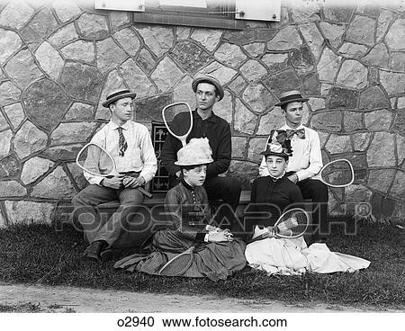 1900S Three Teenaged Boys Sitting On Bench Two Teenaged Girls Sitting On Grass All Holding Tennis Racquets View Large Photo Image Stock Image - 1900S Three Teenaged Boys Sitting On Bench Two Teenaged Girls Sitting On Grass All Holding Tennis Racquets. Fotosearch