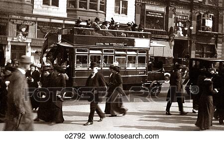 Stock Image - 1900s TURN OF 20TH CENTURY NEW YORK CITY MANHATTAN PEDESTRIANS TRAFFIC CARS DOUBLE DECKER BUS FIFTH AVENUE URBAN STREET SCENE. Fotosearch