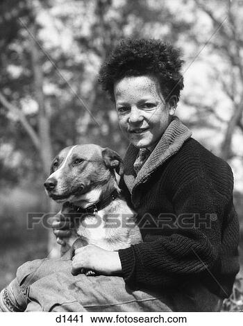 1920S 1930S Smiling Boy Looking At Camera Holding Dog View Large Photo Image Stock Image - 1920S 1930S Smiling Boy Looking At Camera Holding Dog. Fotosearch