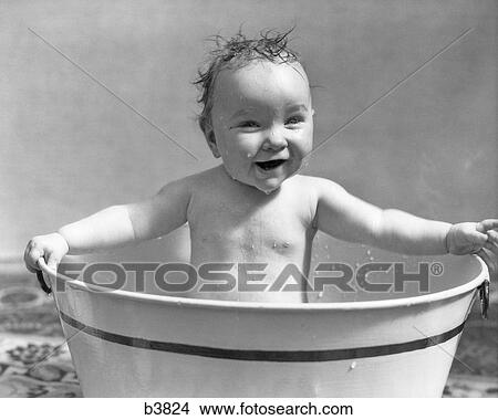 1920s 1930s SMILING HAPPY WET BABY GIRL SITTING BATHING IN METAL WASH TUB View Large Photo Image Picture - 1920s 1930s SMILING HAPPY WET BABY GIRL SITTING BATHING IN METAL WASH TUB. Fotosearch