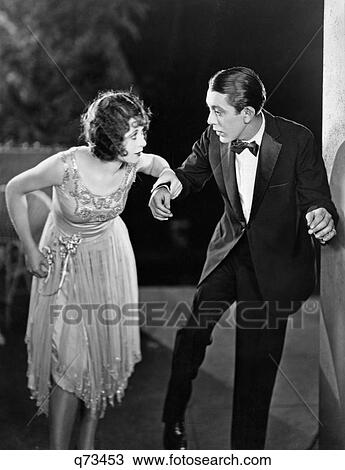 Stock Image - 1920S Couple Man Woman Formal Evening Clothes Dancing Or Stepping Lightly. Fotosearch