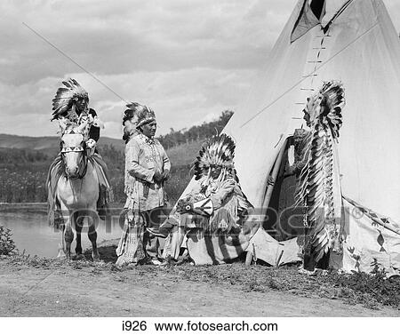 1920S Four Native American Stoney Sioux Indian Men Assembled Beside Tepee Wearing Full Eagle Feather War Bonnets Alberta Canada View Large Photo Image Stock Photograph - 1920S Four Native American Stoney Sioux Indian Men Assembled Beside Tepee Wearing Full Eagle Feather War Bonnets Alberta Canada. Fotosearch