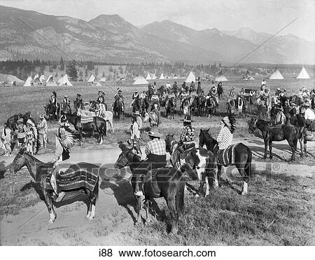 1920s LARGE GROUP OF NATIVE AMERICAN BLACKFOOT INDIANS MEETING BY VILLAGE ON HORSEBACK BRITISH COLUMBIA CANADA View Large Photo Image Stock Photo - 1920s LARGE GROUP OF NATIVE AMERICAN BLACKFOOT INDIANS MEETING BY VILLAGE ON HORSEBACK BRITISH COLUMBIA CANADA. Fotosearch