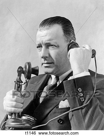 1920s MAN TALKING ON CANDLESTICK TELEPHONE View Large Photo Image Stock Photograph - 1920s MAN TALKING ON CANDLESTICK TELEPHONE. Fotosearch