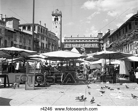 1920s MARKET IN THE PIAZZA DELLE ERBE WITH THE PALAZZO MAFFEI IN BACKGROUND VERONA ITALY View Large Photo Image Stock Photograph - 1920s MARKET IN THE PIAZZA DELLE ERBE WITH THE PALAZZO MAFFEI IN BACKGROUND VERONA ITALY. Fotosearch