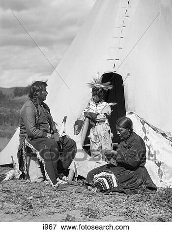 1920S Native American Indian Family Man Woman Child By Tepee Stoney Sioux Tribe Near Alberta Canada View Large Photo Image Stock Photo - 1920S Native American Indian Family Man Woman Child By Tepee Stoney Sioux Tribe Near Alberta Canada. Fotosearch