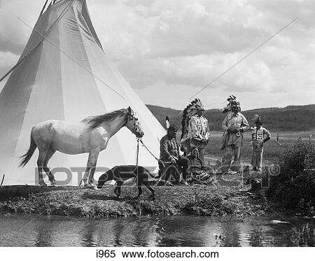 1920s NATIVE AMERICAN INDIAN GROUP BY TEPEE MAN WOMAN CHILD HORSE DOG STONEY SIOUX TRIBE NEAR ALBERTA CANADA View Large Photo Image Stock Photography - 1920s NATIVE AMERICAN INDIAN GROUP BY TEPEE MAN WOMAN CHILD HORSE DOG STONEY SIOUX TRIBE NEAR ALBERTA CANADA. Fotosearch