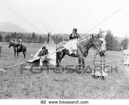 1920s NATIVE AMERICAN SIOUX FAMILY WOMAN MOTHER CHILDREN BY TEPEE GIRL DAUGHTER ON HORSEBACK View Large Photo Image Stock Image - 1920s NATIVE AMERICAN SIOUX FAMILY WOMAN MOTHER CHILDREN BY TEPEE GIRL DAUGHTER ON HORSEBACK. Fotosearch