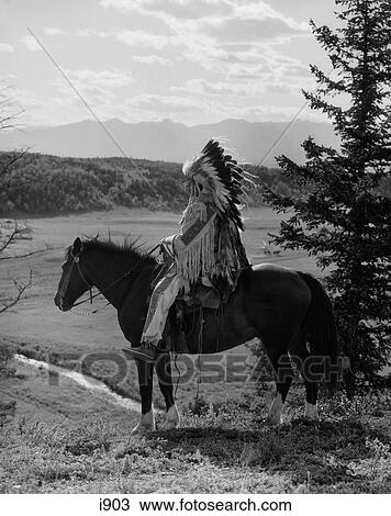 1920S Native American Stoney Sioux Man Full Eagle Feather Headdress On Horseback Looking Over Valley Alberta Canada View Large Photo Image Stock Image - 1920S Native American Stoney Sioux Man Full Eagle Feather Headdress On Horseback Looking Over Valley Alberta Canada . Fotosearch