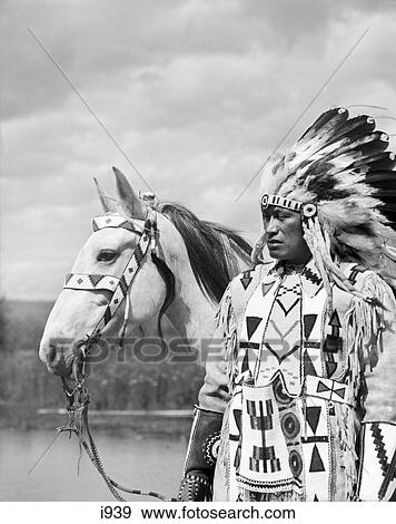 1920S Portrait Native American Indian Chief Full Feather Headdress Beaded Clothes Horse Stoney Sioux Tribe Alberta Canada View Large Photo Image Stock Photo - 1920S Portrait Native American Indian Chief Full Feather Headdress Beaded Clothes Horse Stoney Sioux Tribe Alberta Canada. Fotosearch