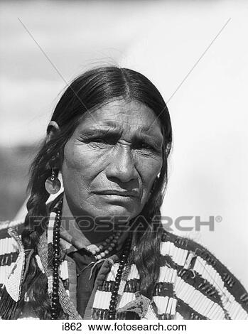 Stock Image - 1920S Portrait Native American Man Serious Expression Looking At Camera Stoney Sioux Tribe Alberta Canada . Fotosearch