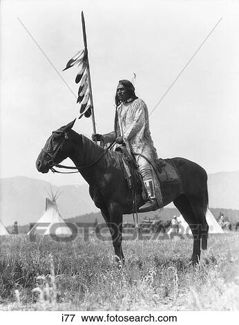 1920S Single Native American Stoney Sioux Indian Man Sitting On Horse Holding Eagle Feathered Decorated Lance Alberta Canada View Large Photo Image Stock Photo - 1920S Single Native American Stoney Sioux Indian Man Sitting On Horse Holding Eagle Feathered Decorated Lance Alberta Canada . Fotosearch