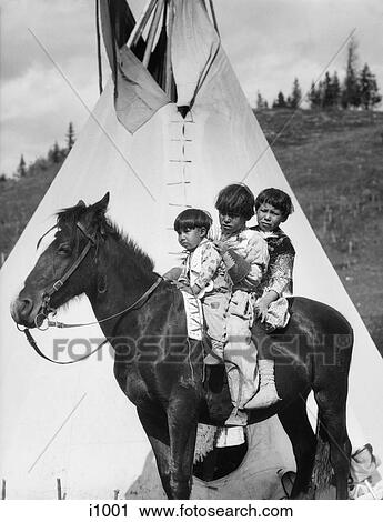 1920S Three Native American Stoney Sioux Indian Children Riding On Horse By Tepee Alberta Canada View Large Photo Image Stock Image - 1920S Three Native American Stoney Sioux Indian Children Riding On Horse By Tepee Alberta Canada. Fotosearch