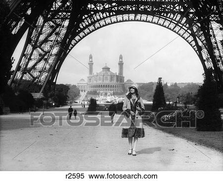 1920S Woman Walking Under The Eiffel Tower With The Trocadero In Background Paris France View Large Photo Image Stock Photography - 1920S Woman Walking Under The Eiffel Tower With The Trocadero In Background Paris France. Fotosearch