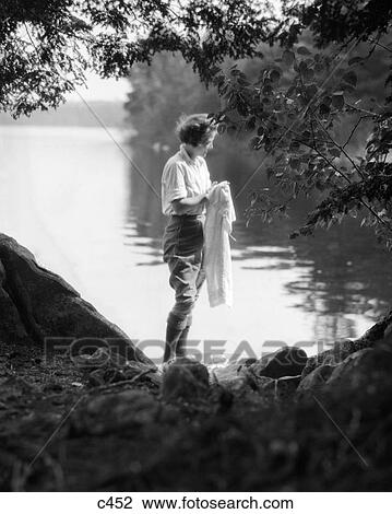 1930s 1920s WOMAN CAMPING OUTDOORS WASHING CLOTHES IN LAKE View Large Photo Image Stock Image - 1930s 1920s WOMAN CAMPING OUTDOORS WASHING CLOTHES IN LAKE. Fotosearch