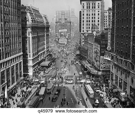 1930S 1935 Times Square Looking North From Times Tower Midtown Manhattan Pedestrians Traffic Cars Trolleys Buildings Marquees View Large Photo Image Stock Photo - 1930S 1935 Times Square Looking North From Times Tower Midtown Manhattan Pedestrians Traffic Cars Trolleys Buildings Marquees. Fotosearch