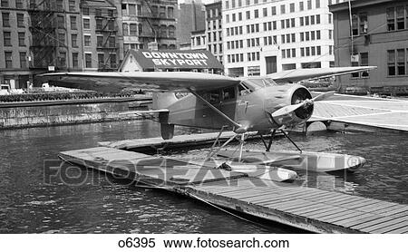 1930s 1939 WACO AIRPLANE ON FLOATS IN EAST RIVER AT WALL STREET DOWNTOWN SKYPORT NEW YORK CITY USA View Large Photo Image Stock Photography - 1930s 1939 WACO AIRPLANE ON FLOATS IN EAST RIVER AT WALL STREET DOWNTOWN SKYPORT NEW YORK CITY USA. Fotosearch