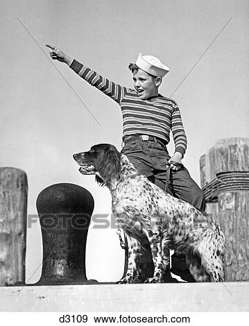 1930S 1940S Boy Wearing Sailor Hat And Striped Tee Shirt On Dock With His English Setter Dog View Large Photo Image Stock Photo - 1930S 1940S Boy Wearing Sailor Hat And Striped Tee Shirt On Dock With His English Setter Dog. Fotosearch