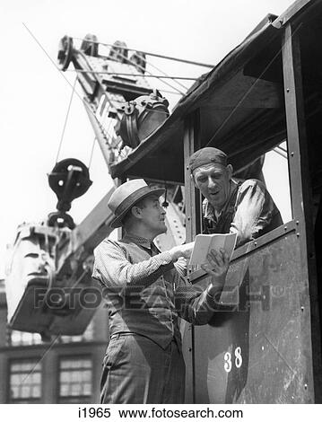 1930s 1940s CONSTRUCTION WORKERS DISCUSSING PROJECT ON STEAM SHOVEL View Large Photo Image Stock Photography - 1930s 1940s CONSTRUCTION WORKERS DISCUSSING PROJECT ON STEAM SHOVEL. Fotosearch