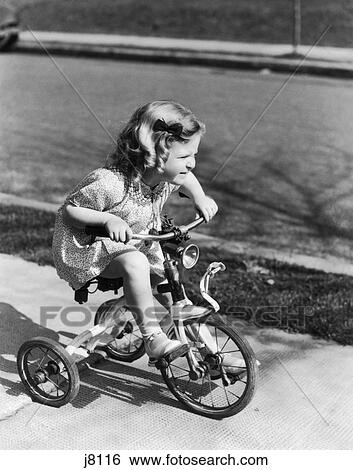 girl riding tricycle