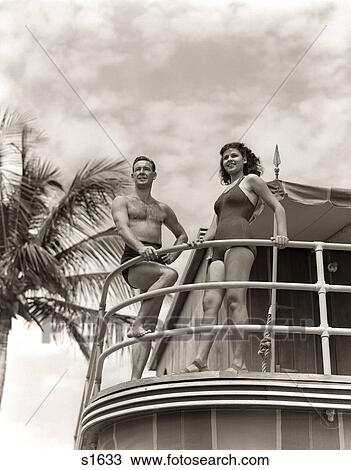 1930s 1940s MAN WOMAN COUPLE IN SWIM WEAR BATHING SUITS TROPICAL POOL SIDE VACATION HOTEL MIAMI BEACH FLORIDA USA View Large Photo Image Stock Image - 1930s 1940s MAN WOMAN COUPLE IN SWIM WEAR BATHING SUITS TROPICAL POOL SIDE VACATION HOTEL MIAMI BEACH FLORIDA USA. Fotosearch