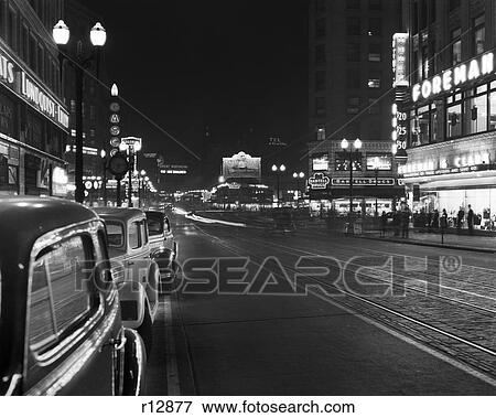 1930s 1940s NIGHT NEON SIGNS AND PARKED CARS ALONG 4TH AVENUE SEATTLE WASHINGTON USA View Large Photo Image Stock Photo - 1930s 1940s NIGHT NEON SIGNS AND PARKED CARS ALONG 4TH AVENUE SEATTLE WASHINGTON USA. Fotosearch