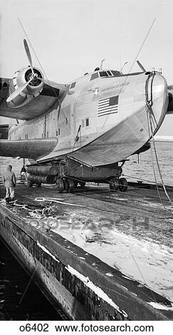 1930s 1940s PAN AMERICAN AIRWAYS FLYING BOAT CLIPPER BOEING 314 HELD BY MOORING LINE BEING LAUNCHED INTO WATER View Large Photo Image Stock Image - 1930s 1940s PAN AMERICAN AIRWAYS FLYING BOAT CLIPPER BOEING 314 HELD BY MOORING LINE BEING LAUNCHED INTO WATER. Fotosearch