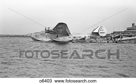 1930s 1940s PAN AMERICAN AIRWAYS CLIPPER FLYING BOAT BOEING 314 FLOATING AT DOCK IN THE WATER View Large Photo Image Stock Image - 1930s 1940s PAN AMERICAN AIRWAYS CLIPPER FLYING BOAT BOEING 314 FLOATING AT DOCK IN THE WATER. Fotosearch