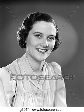 Picture - 1930s 1940s PORTRAIT OF SMILING WOMAN WEARING BUTTON DOWN BLOUSE LOOKING AT CAMERA. Fotosearch