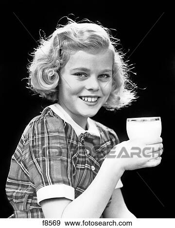 1930s 1940s SMILING BLOND GIRL PLAID SHIRT HOLDING GLASS OF MILK LOOKING AT CAMERA View Large Photo Image Stock Photo - 1930s 1940s SMILING BLOND GIRL PLAID SHIRT HOLDING GLASS OF MILK LOOKING AT CAMERA. Fotosearch