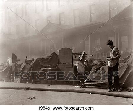 1930s 1940s YOUNG MAN LOOKING AT FURNITURE STACKED ON SIDEWALK IN FRONT OF ROW HOUSE PARTIALLY OBSCURED BY SMOKE FROM FIRE View Large Photo Image Stock Photography - 1930s 1940s YOUNG MAN LOOKING AT FURNITURE STACKED ON SIDEWALK IN FRONT OF ROW HOUSE PARTIALLY OBSCURED BY SMOKE FROM FIRE. Fotosearch