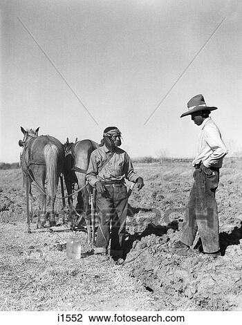 1930s 2 NATIVE AMERICAN INDIAN MEN FARMERS TALKING IN PLOWED FIELD HORSE DRAWN PLOW SAN ILDEFONSO PUEBLO NEW MEXICO USA View Large Photo Image Stock Image - 1930s 2 NATIVE AMERICAN INDIAN MEN FARMERS TALKING IN PLOWED FIELD HORSE DRAWN PLOW SAN ILDEFONSO PUEBLO NEW MEXICO USA. Fotosearch