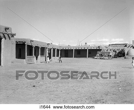 1930s ADOBE BUILDINGS ARCHITECTURE OF NORTH PLAZA OF SAN ILDEFONSO PUEBLO NEW MEXICO USA View Large Photo Image Picture - 1930s ADOBE BUILDINGS ARCHITECTURE OF NORTH PLAZA OF SAN ILDEFONSO PUEBLO NEW MEXICO USA. Fotosearch