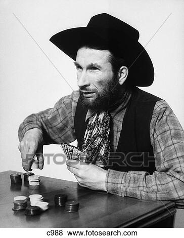 1930s BEARDED MAN COWBOY PLAYING CARDS GAMBLING BETTING POKER CHIPS View Large Photo Image Stock Photo - 1930s BEARDED MAN COWBOY PLAYING CARDS GAMBLING BETTING POKER CHIPS. Fotosearch