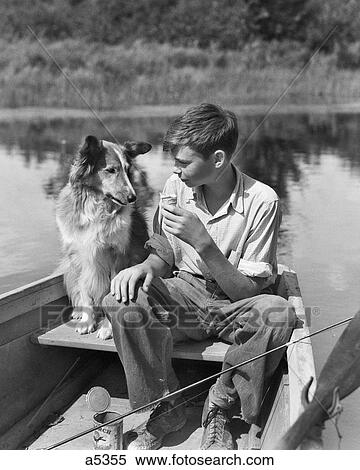 1930S Boy And Collie Dog Together In Rowboat With Fishing Pole Can Of Worms On Pond Eating Sharing Ice Cream Cone View Large Photo Image Stock Photography - 1930S Boy And Collie Dog Together In Rowboat With Fishing Pole Can Of Worms On Pond Eating Sharing Ice Cream Cone. Fotosearch