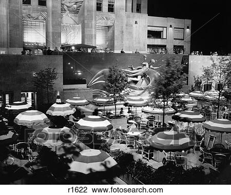 1930s CAFE UMBRELLAS TABLES EVENING AT PROMETHEUS FOUNTAIN ROCKEFELLER CENTER MANHATTAN NEW YORK CITY NY USA View Large Photo Image Stock Image - 1930s CAFE UMBRELLAS TABLES EVENING AT PROMETHEUS FOUNTAIN ROCKEFELLER CENTER MANHATTAN NEW YORK CITY NY USA. Fotosearch