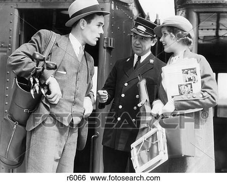 1930s COUPLE STANDING BY TRAIN WORRIED MAN WITH GOLF CLUBS WOMAN WITH TENNIS RACQUET CONDUCTOR ASKING FOR MISPLACED TICKET View Large Photo Image Stock Photograph - 1930s COUPLE STANDING BY TRAIN WORRIED MAN WITH GOLF CLUBS WOMAN WITH TENNIS RACQUET CONDUCTOR ASKING FOR MISPLACED TICKET. Fotosearch