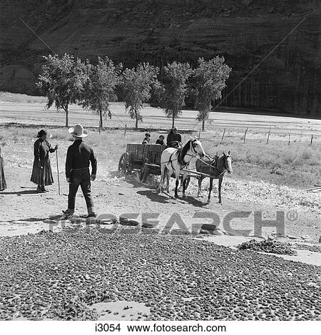 1930S Group Of Native American Navajo Indians Drying Corn Watching Woman Children Riding In Cart Wagon Drawn By Two Horses View Large Photo Image Picture - 1930S Group Of Native American Navajo Indians Drying Corn Watching Woman Children Riding In Cart Wagon Drawn By Two Horses. Fotosearch
